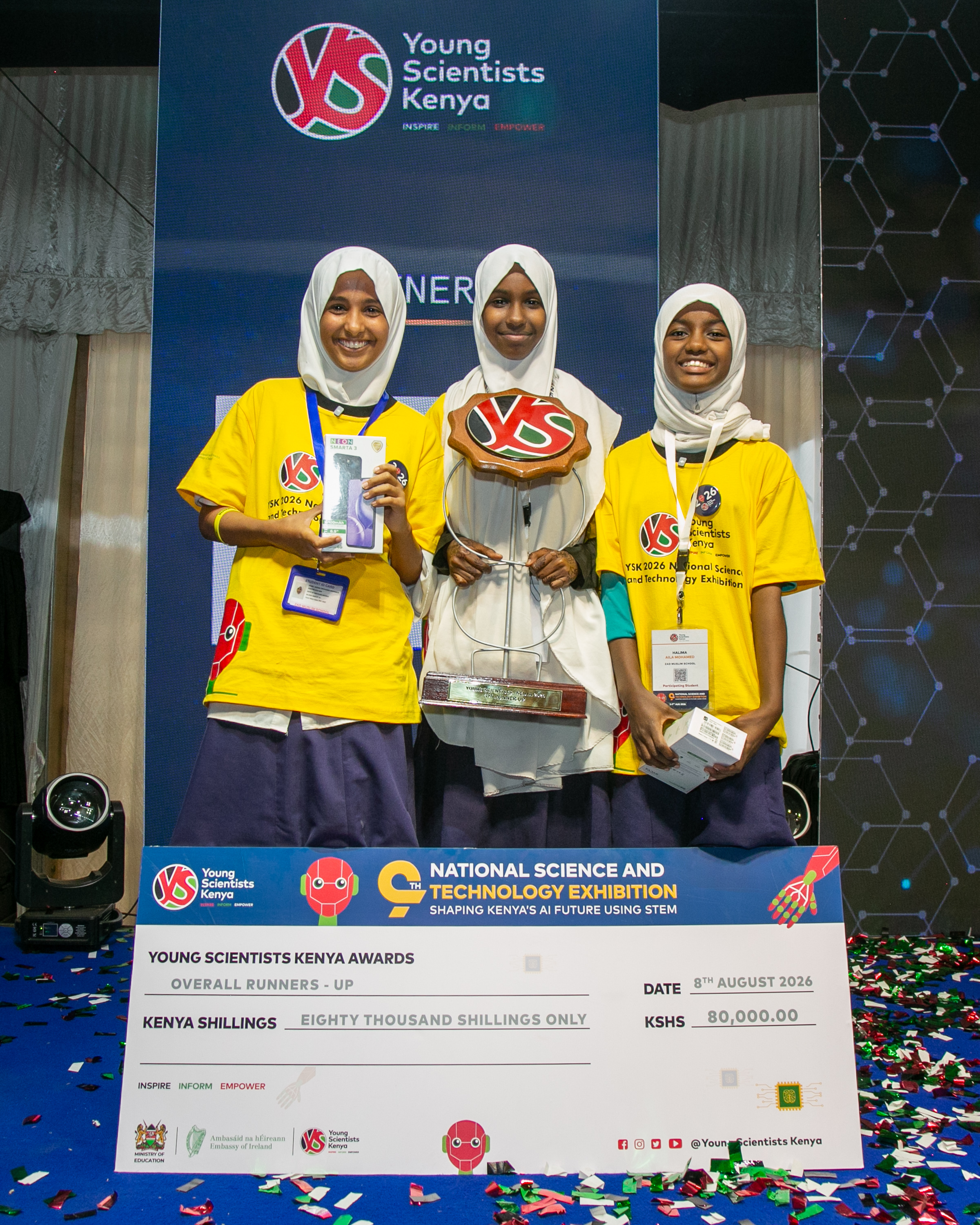 Sake Tadicha, Manal Mohamed and Halima Mohamed of Zad Muslim School in Marsabit County celebrate after emerging Overall Runners-Up at the ninth Young Scientists Kenya National Science and Technology Exhibition held at Moi Girls High School in Nairobi.