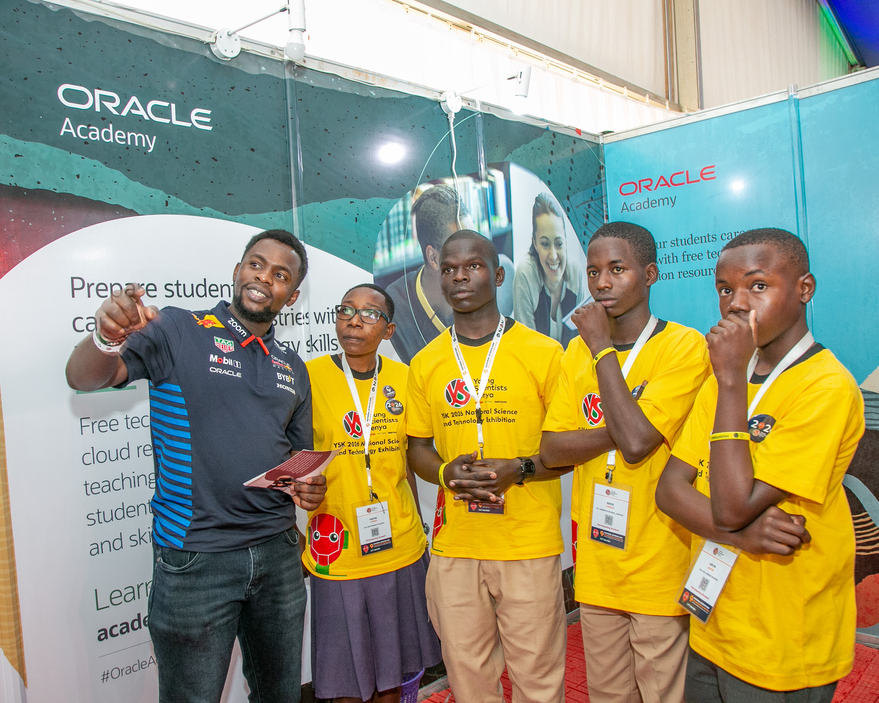 Billy Otieno, Enterprise AI Cloud Solutions Architect at Oracle (left), engages Young Scientists Kenya participants at the Oracle booth during the ninth Young Scientists Kenya National Science and Technology Exhibition at Moi Girls High School in Nairobi.