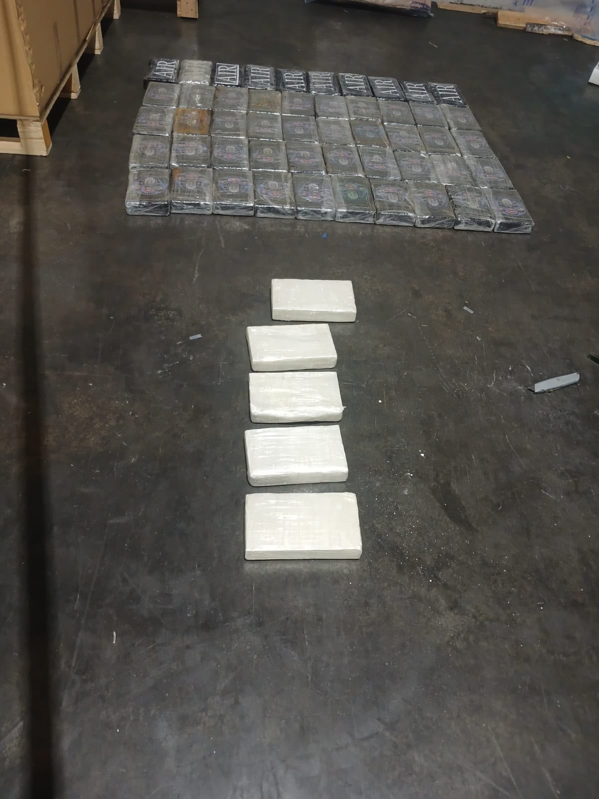 The second interception targeted the cargo section, where four boxes containing approximately 250 kilograms of suspected cocaine were seized.