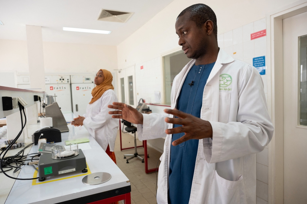 Senegalese pharmacist and Teranga Pharma CEO Dr. Mouhamadou Sow shows one of his laboratories in Mbao. Photo credit: SEYLLOU/AFP